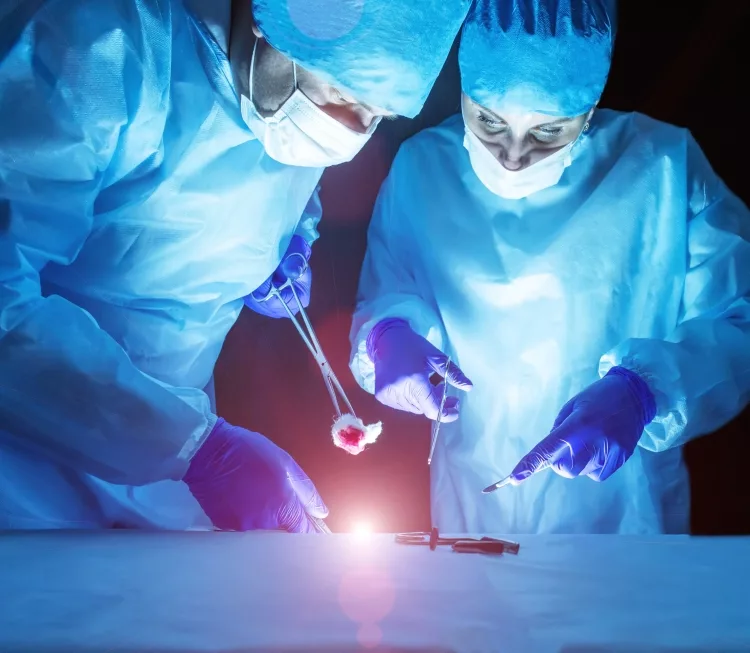 Two doctors perform laser surgery to treat hemorrhoids